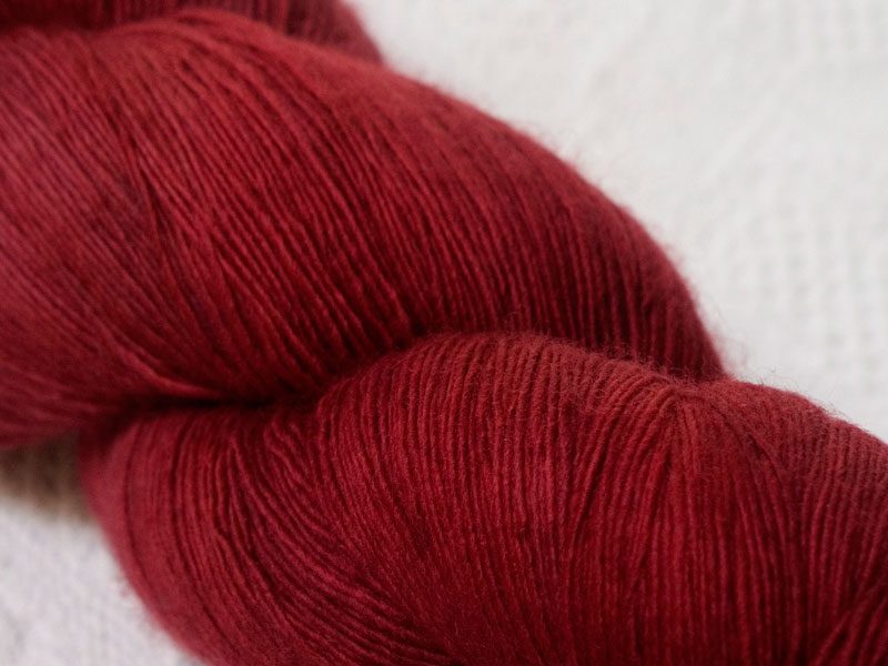 Semi-solid deep red Falklands Merino laceweight yarn hand-dyed by Triskelion Yarns
