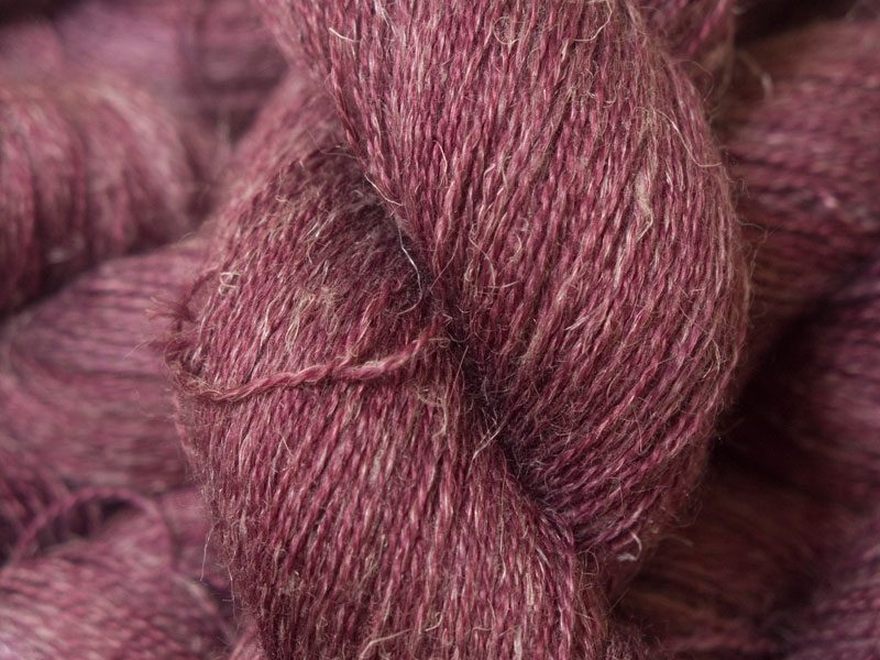 Mid-tone violet red Baby Alpaca, silk and linen heavy laceweight yarn. Hand-dyed by Triskelion Yarn.