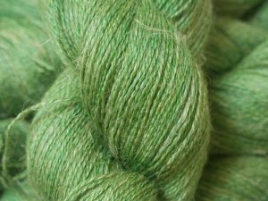 Mid-tone grassy green Baby Alpaca, silk and linen heavy laceweight yarn. Hand-dyed by Triskelion Yarn.