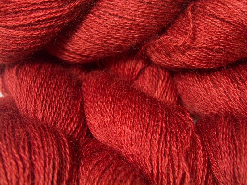 Mid-toned red hand-dyed Wensleydale DK/ Double Knit yarn. Hand-dyed by Triskelion Yarn