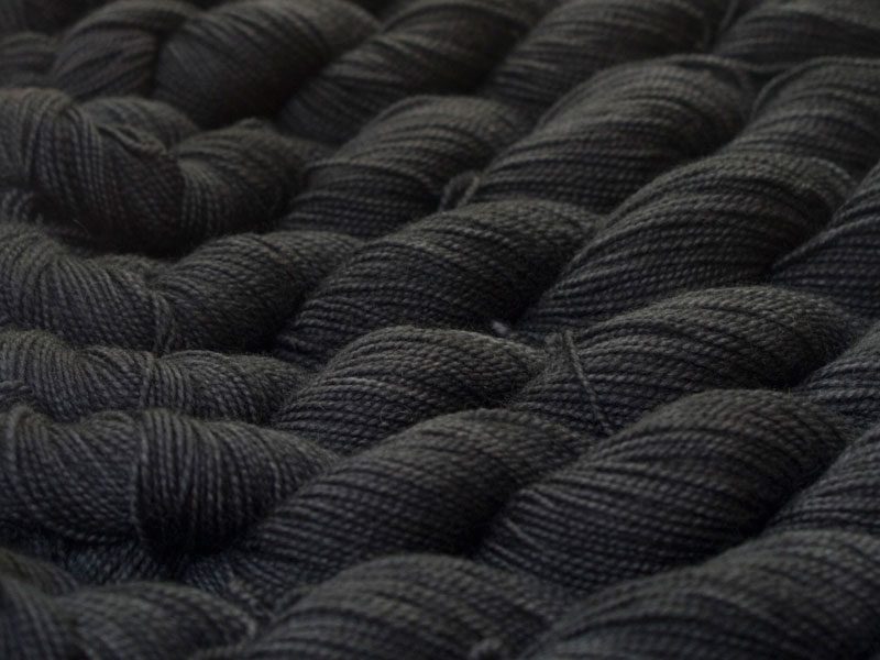 Soft charcoal black superwash Bluefaced Leicester (BFL) 4-ply/fingering/sock yarn. Hand-dyed by Triskelion Yarn