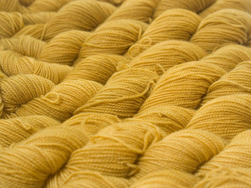 Warm yellow superwash Bluefaced Leicester (BFL) 4-ply/fingering/sock yarn. Hand-dyed by Triskelion Yarn