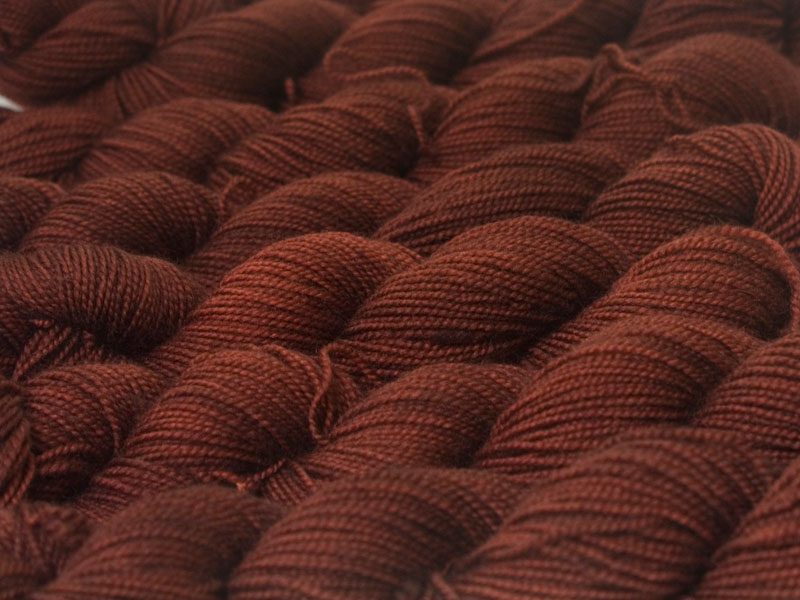 Rich, dark chestnut brown superwash Bluefaced Leicester (BFL) 4-ply/fingering/sock yarn. Hand-dyed by Triskelion Yarn