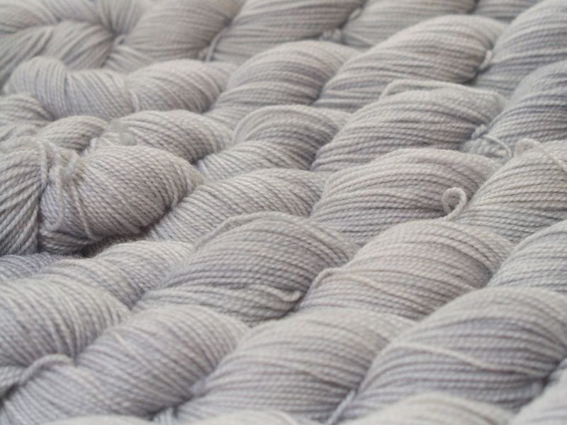 Pale silvery grey superwash Bluefaced Leicester (BFL) 4-ply/fingering/sock yarn. Hand-dyed by Triskelion Yarn