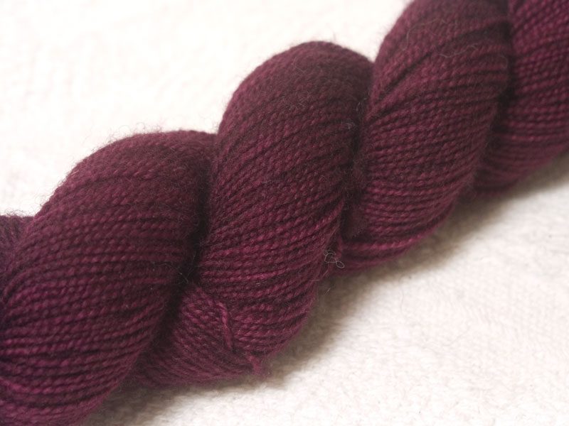 Mulberry purple red superwash Bluefaced Leicester (BFL) 4-ply/fingering/sock yarn. Hand-dyed by Triskelion Yarn