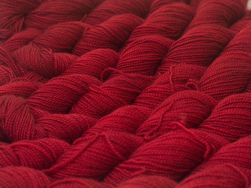 Deep red superwash Bluefaced Leicester (BFL) 4-ply/fingering/sock yarn. Hand-dyed by Triskelion Yarn