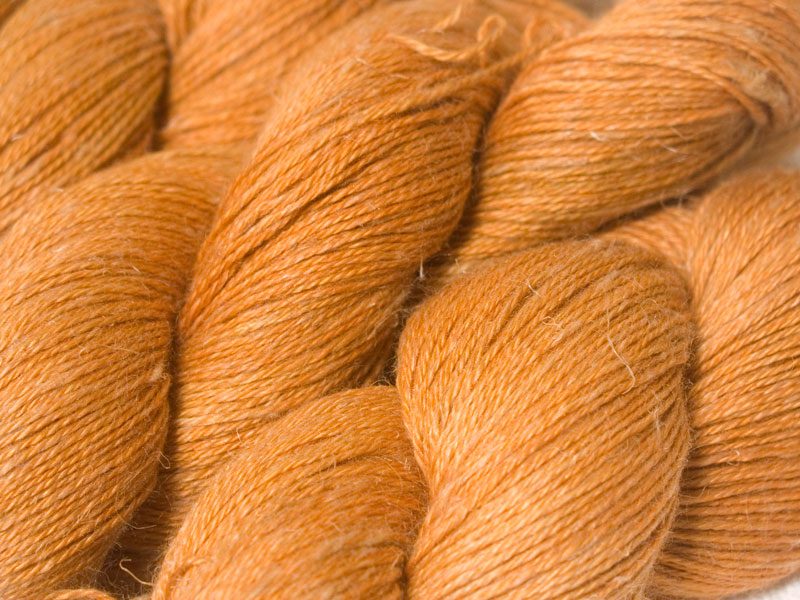 Semi-solid light fiery orange Baby Alpaca, silk and linen 4-ply yarn. Hand-dyed by Triskelion Yarn.