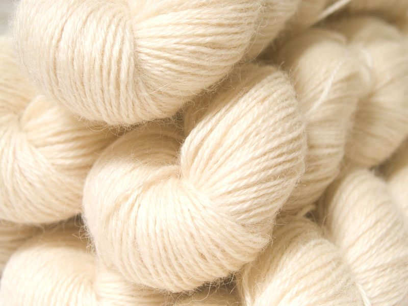 Solid creamy ivory hand-dyed Wensleydale DK/ Double Knit yarn. Hand-dyed by Triskelion Yarn