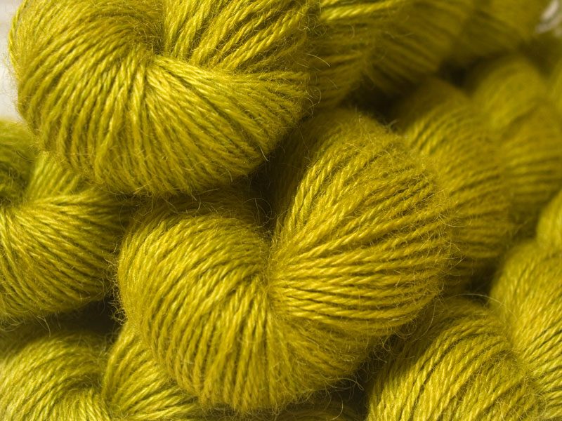 Semi-solid chartreuse green, with ochre and spring green tones hand-dyed Wensleydale DK/ Double Knit yarn. Hand-dyed by Triskelion Yarn