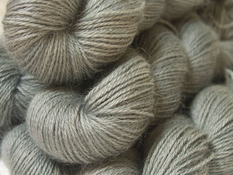 Semi-solid light to mid surf grey, with sea green and turquoise tones hand-dyed Wensleydale DK/ Double Knit yarn. Hand-dyed by Triskelion Yarn