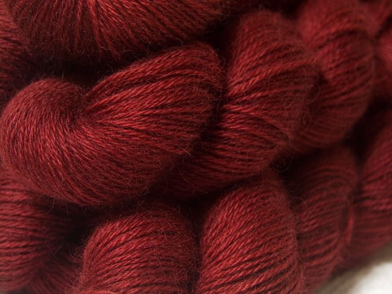 Semi-solid mid to dark red, with brick and scarlet tones hand-dyed Wensleydale DK/ Double Knit yarn. Hand-dyed by Triskelion Yarn