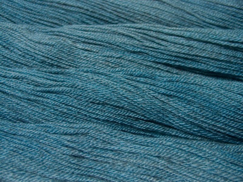 Semi-solid light sky blue, with powder blue and grey tones Bluefaced Leicester (BFL) / Masham aran yarn. Hand-dyed by Triskelion Yarn