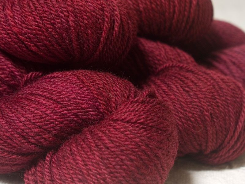 Semi-solid dark rose, with tones of pink and carmine Bluefaced Leicester (BFL) / Masham aran yarn. Hand-dyed by Triskelion Yarn