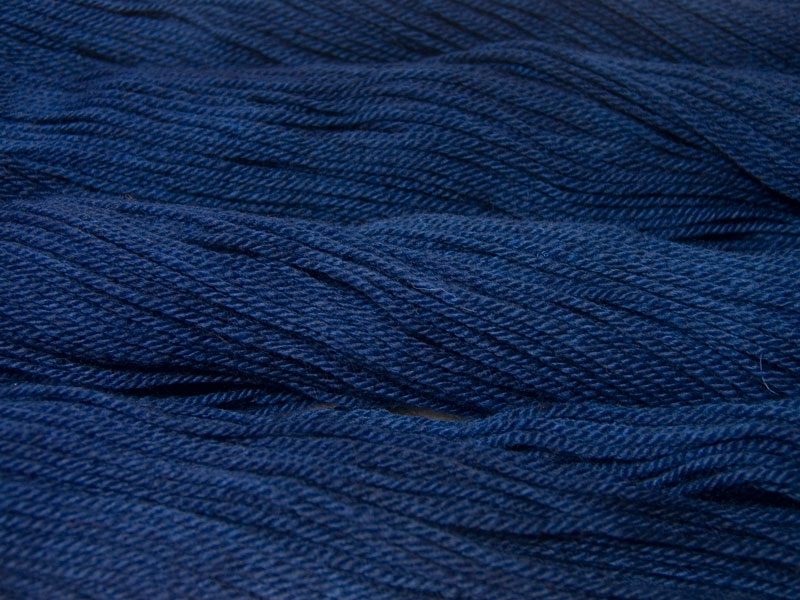 Semi-solid midnight blue, with violet and cobalt tones Bluefaced Leicester (BFL) / Masham aran yarn. Hand-dyed by Triskelion Yarn