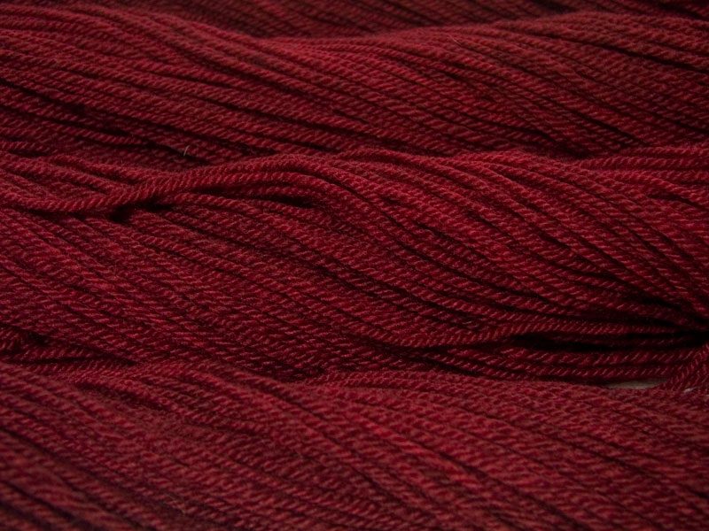 Semi-solid dark red, with tones of cherry and carmine Bluefaced Leicester (BFL) / Masham aran yarn. Hand-dyed by Triskelion Yarn