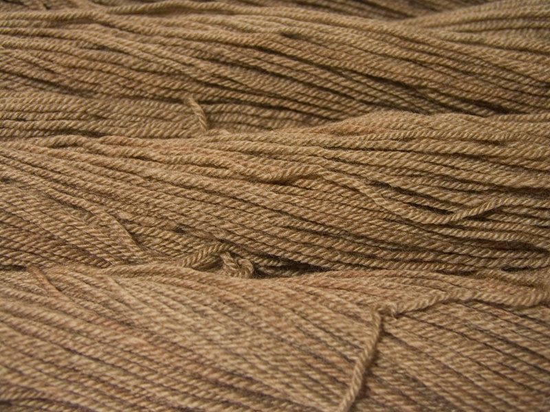 Semi-solid light brown, with oakwood and tawny tones Bluefaced Leicester (BFL) / Masham aran yarn. Hand-dyed by Triskelion Yarn