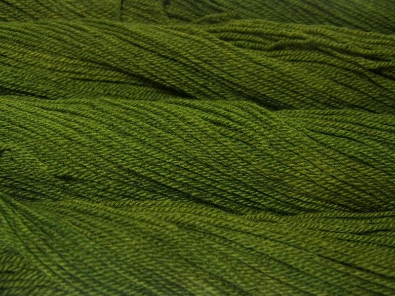 Semi-solid foliage green, with ochre and olive tones Bluefaced Leicester (BFL) / Masham aran yarn. Hand-dyed by Triskelion Yarn