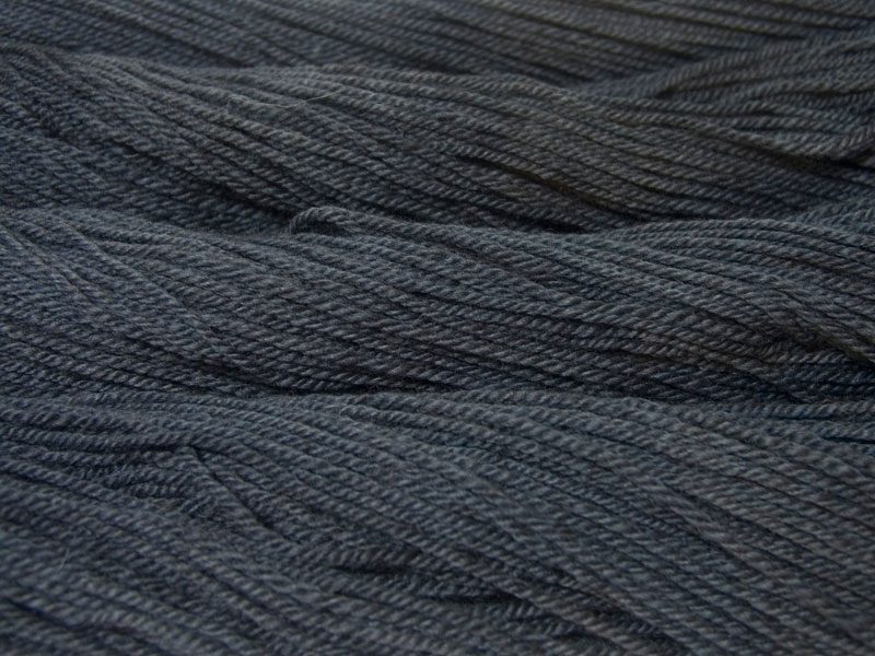 Semi-solid mid to dark grey, with tones of stormy blue and violet Bluefaced Leicester (BFL) / Masham aran yarn. Hand-dyed by Triskelion Yarn