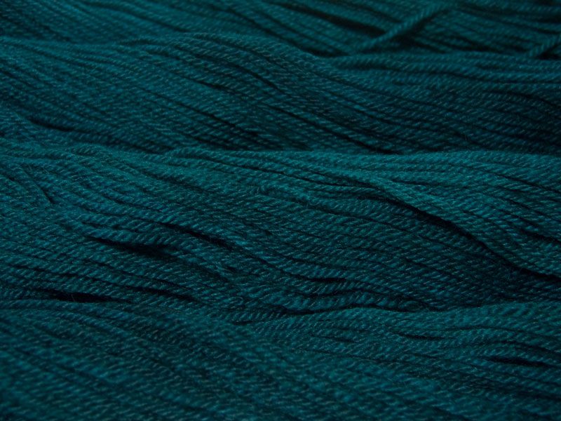 Semi-solid dark sea blue, with petrol blue, teal and sea green tones Bluefaced Leicester (BFL) / Masham aran yarn. Hand-dyed by Triskelion Yarn