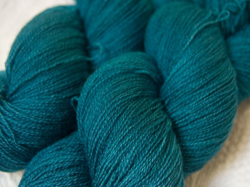 Semi-solid dark turquoise Bluefaced Leicester laceweight yarn hand-dyed by Triskelion Yarns