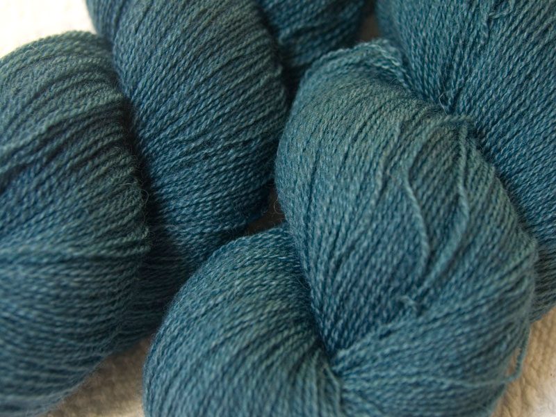 Semi-solid mid-blue, with grey and air force blue tones Bluefaced Leicester laceweight yarn hand-dyed by Triskelion Yarns
