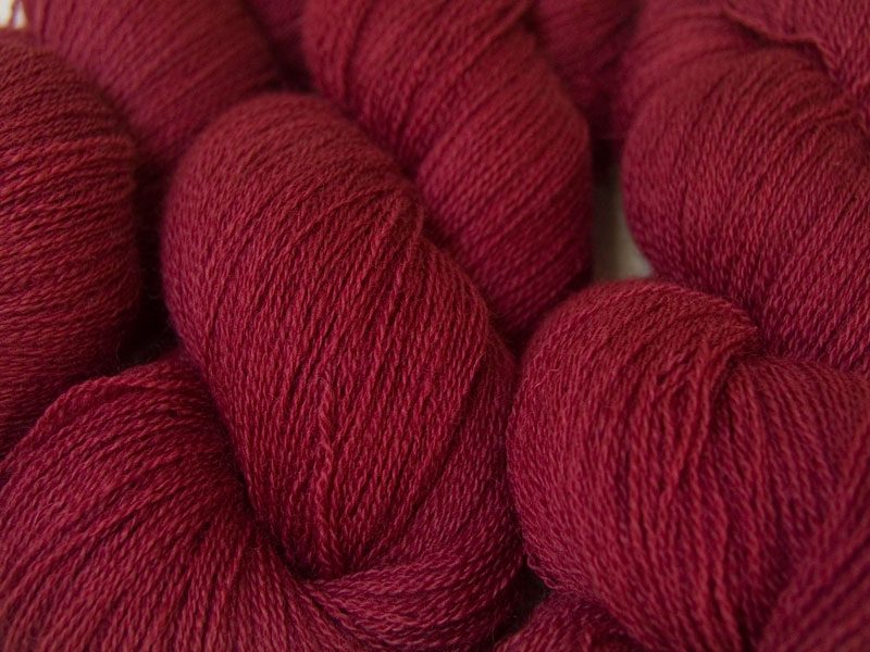 Semi-solid dark rose, with tones of pink and carmine Bluefaced Leicester laceweight yarn hand-dyed by Triskelion Yarns