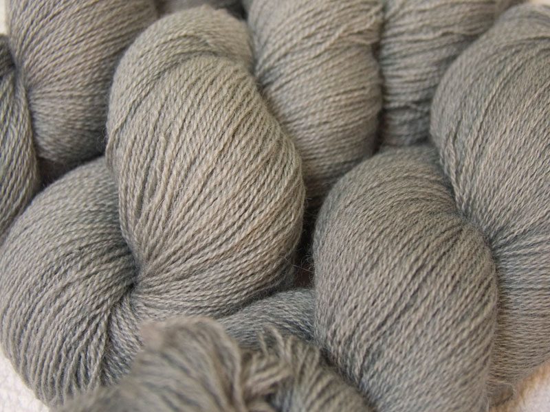 Semi-solid light to mid surf grey, with sea green and turquoise tones Bluefaced Leicester laceweight yarn hand-dyed by Triskelion Yarns