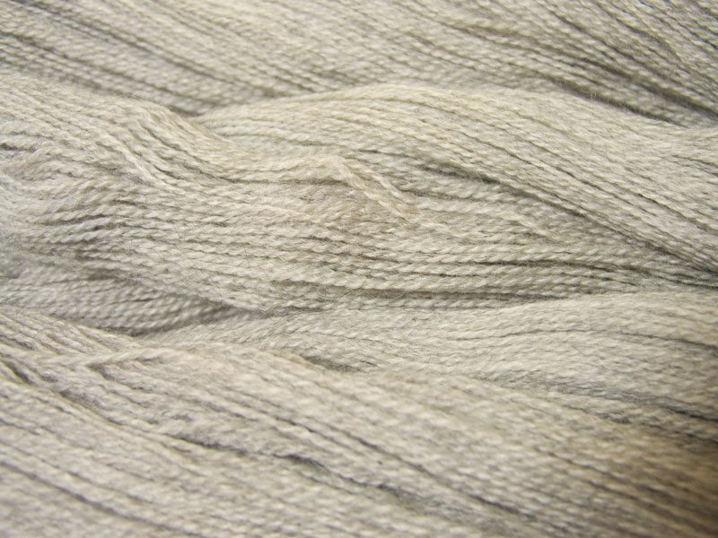 Semi-solid pale grey, with bright ash and silver tones Bluefaced Leicester (BFL) / Gotland 4-ply (fingering) yarn. Hand-dyed by Triskelion Yarn