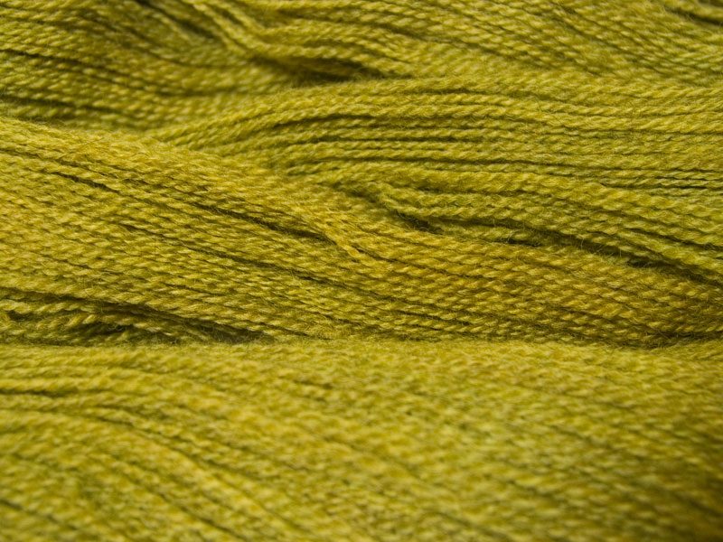 Semi-solid chartreuse green, with ochre and spring green tones Bluefaced Leicester (BFL) / Gotland 4-ply (fingering) yarn. Hand-dyed by Triskelion Yarn