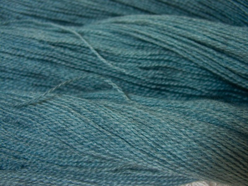 Semi-solid light sky blue, with powder blue and grey tones Bluefaced Leicester (BFL) / Gotland 4-ply (fingering) yarn. Hand-dyed by Triskelion Yarn