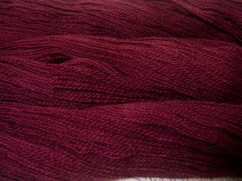 Semi-solid dark rose, with tones of pink and carmine Bluefaced Leicester (BFL) / Gotland 4-ply (fingering) yarn. Hand-dyed by Triskelion Yarn