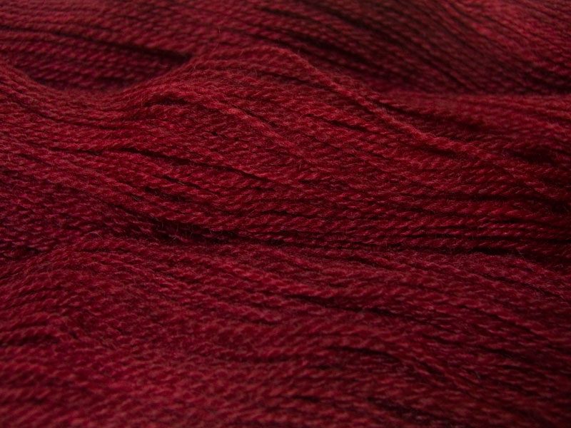 Semi-solid dark red, with tones of cherry and carmine Bluefaced Leicester (BFL) / Gotland 4-ply (fingering) yarn. Hand-dyed by Triskelion Yarn