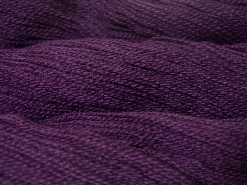 Semi-solid dark purple, with red-violet and royal purple tones Bluefaced Leicester (BFL) / Gotland 4-ply (fingering) yarn. Hand-dyed by Triskelion Yarn