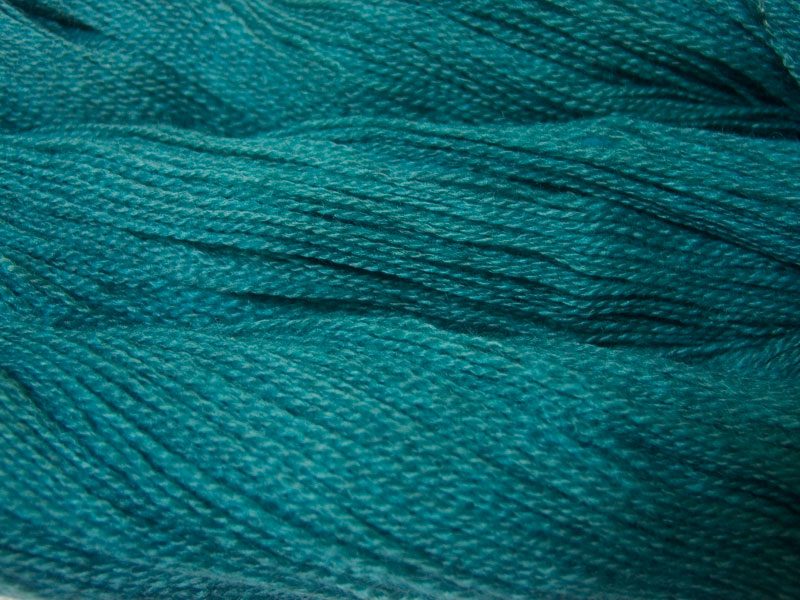 Semi-solid turquoise, with sea blue and grey tones Bluefaced Leicester (BFL) / Gotland 4-ply (fingering) yarn. Hand-dyed by Triskelion Yarn