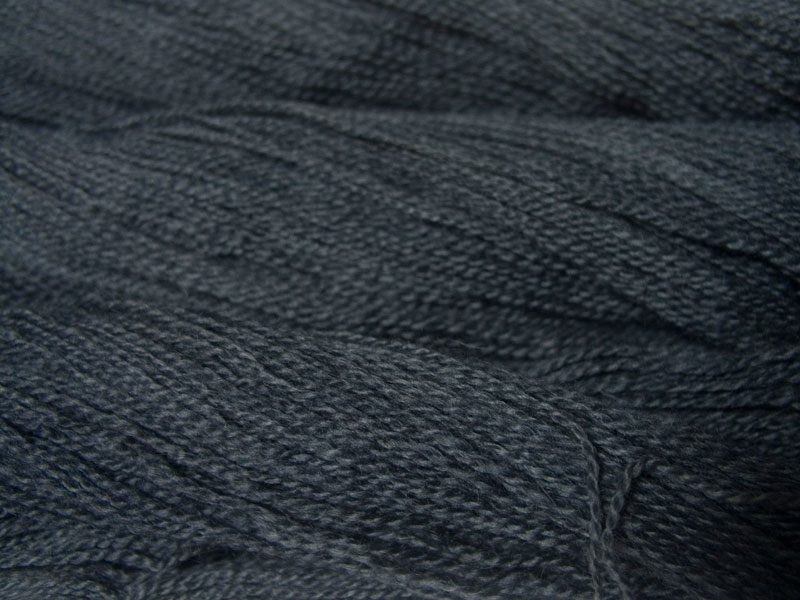 Semi-solid mid to dark grey, with tones of stormy blue and violet Bluefaced Leicester (BFL) / Gotland 4-ply (fingering) yarn. Hand-dyed by Triskelion Yarn