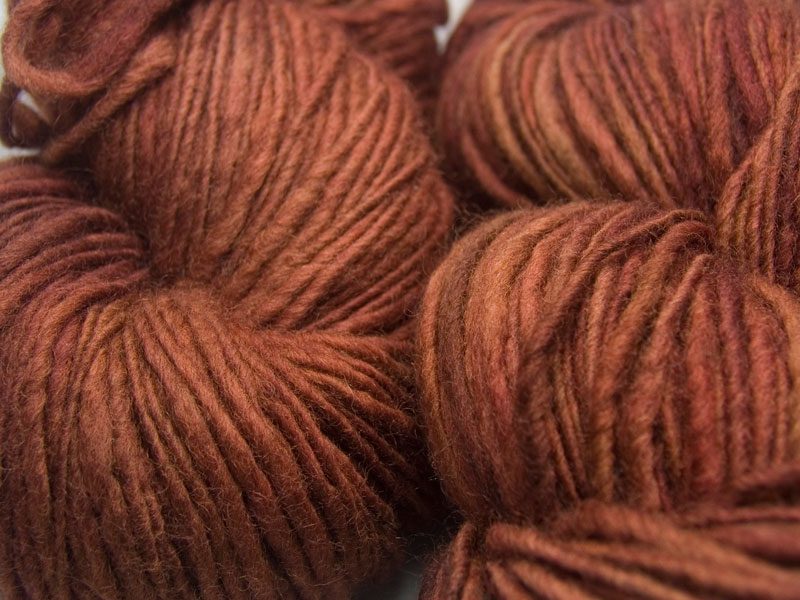 Epona - rich, dark chestnut brown Corriedale thick and thin slub yarn. Hand-dyed by Triskelion Yarn.