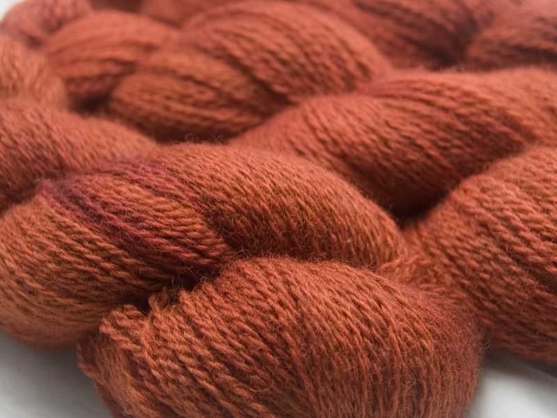 Burnt orange with dark tonal variations Bluefaced Leicester (BFL) / Masham aran yarn. Hand-dyed by Triskelion Yarn