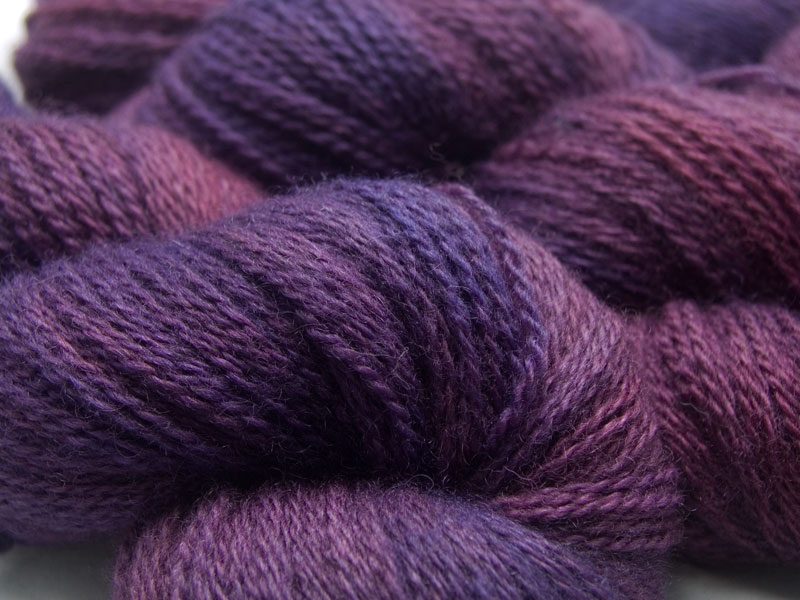 Mid-tone violet red with purple variations Bluefaced Leicester (BFL) / Masham aran yarn. Hand-dyed by Triskelion Yarn