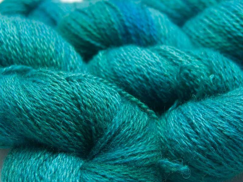 Mid-tone turquoise with blue-green variations Bluefaced Leicester (BFL) / Masham aran yarn. Hand-dyed by Triskelion Yarn