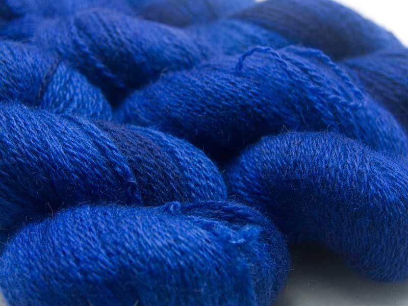 Semi-solid deep blue with dark tonal variations Bluefaced Leicester (BFL) / Masham aran yarn. Hand-dyed by Triskelion Yarn