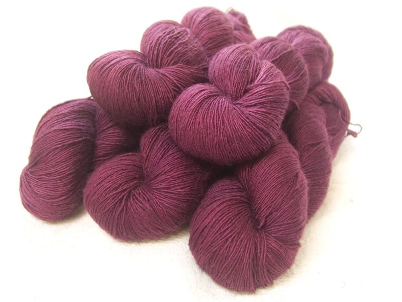 Damson - Mid-tone violet red Falklands Merino and silk blend yarn. Hand-dyed by Triskelion Yarn.