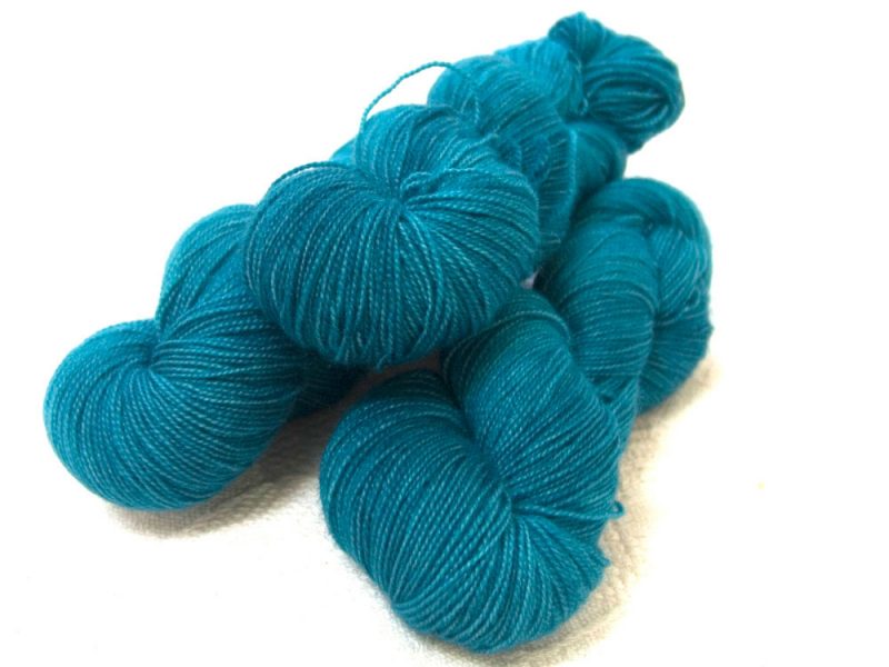 Semi-solid dark turquoise superwash Bluefaced Leicester (BFL) 4-ply/fingering/sock yarn. Hand-dyed by Triskelion Yarn