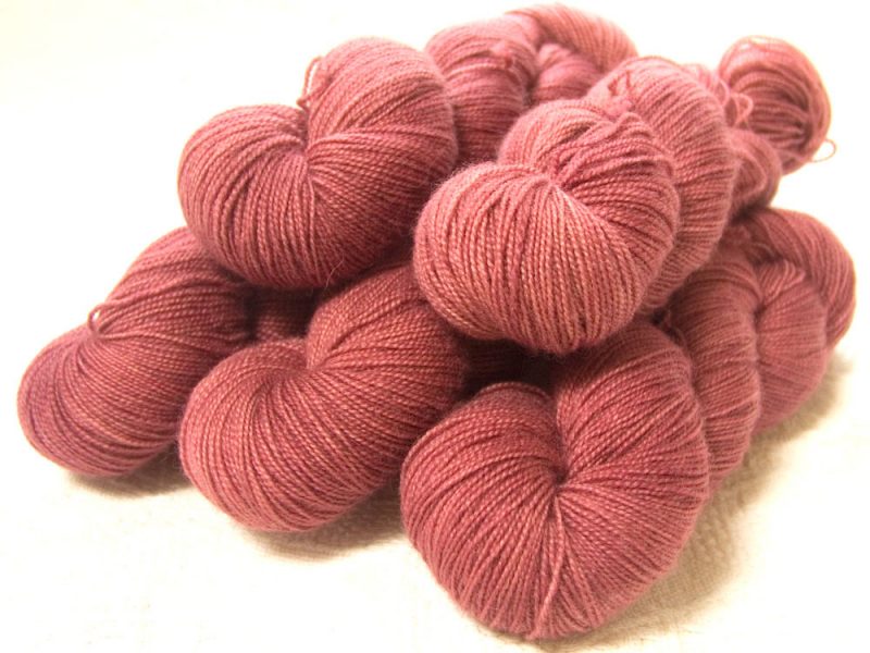 Semi-solid dawn pink, with tones of scarlet and rose superwash Bluefaced Leicester (BFL) 4-ply/fingering/sock yarn. Hand-dyed by Triskelion Yarn