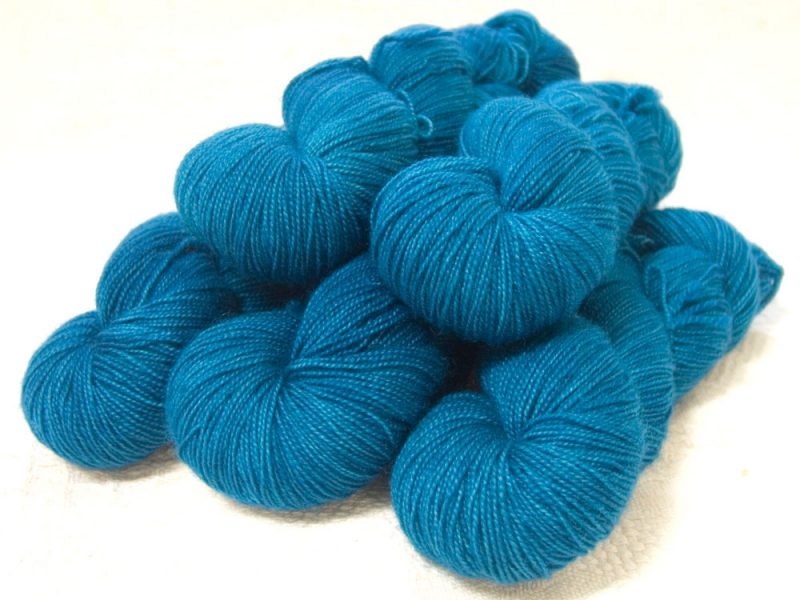 Semi-solid dark blue, with cobalt, sea blue and dark grey tones superwash Bluefaced Leicester (BFL) 4-ply/fingering/sock yarn. Hand-dyed by Triskelion Yarn