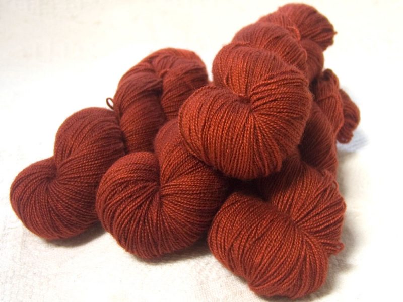 Semi-solid dark orange, with tones of copper, vermillion and russet superwash Bluefaced Leicester (BFL) 4-ply/fingering/sock yarn. Hand-dyed by Triskelion Yarn