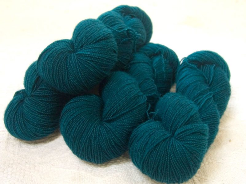 Semi-solid dark sea blue, with petrol blue, teal and sea green tones superwash Bluefaced Leicester (BFL) 4-ply/fingering/sock yarn. Hand-dyed by Triskelion Yarn