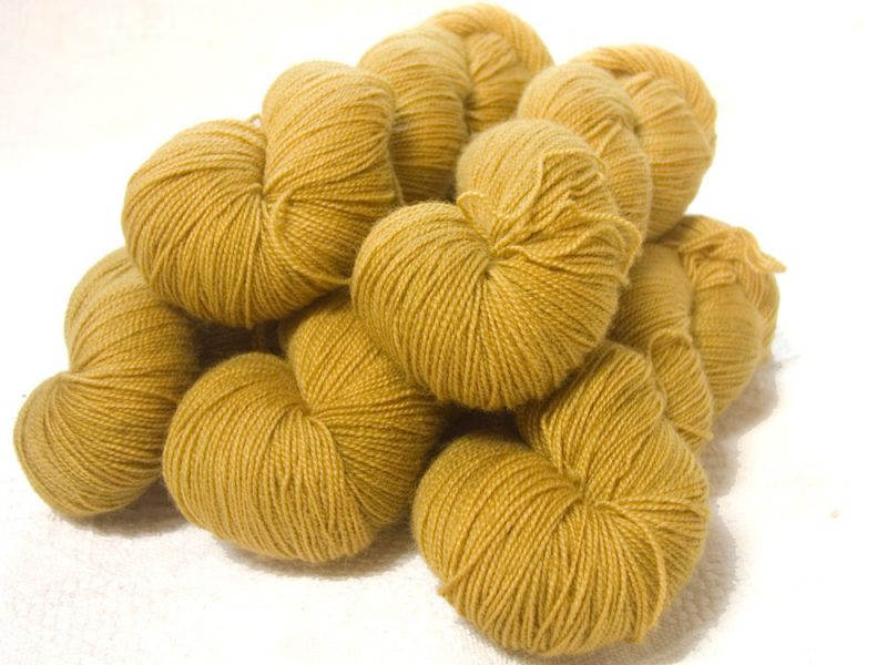 Semi-solid yellow, with tones of ochre and antique gold superwash Bluefaced Leicester (BFL) 4-ply/fingering/sock yarn. Hand-dyed by Triskelion Yarn