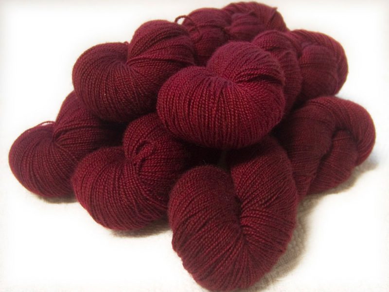 Semi-solid mid to dark red, with brick and scarlet tones superwash Bluefaced Leicester (BFL) 4-ply/fingering/sock yarn. Hand-dyed by Triskelion Yarn