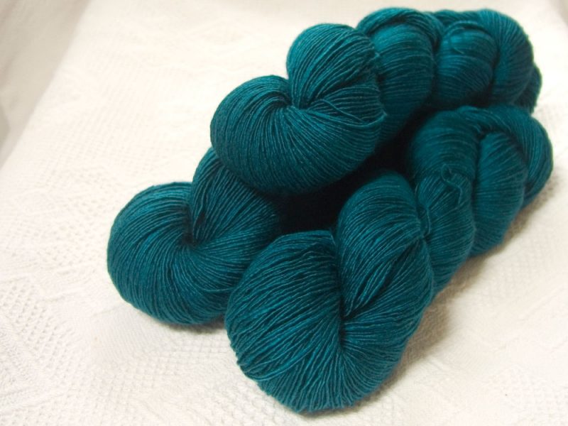 Llŷr - Semi-solid deep sea teal blue Falklands Merino and silk blend yarn. Hand-dyed by Triskelion Yarn.