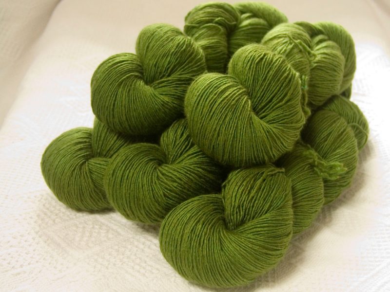 Rum and Laverbread - Semi-solid foliage green, with ochre and olive tones Falklands Merino and silk blend yarn. Hand-dyed by Triskelion Yarn.